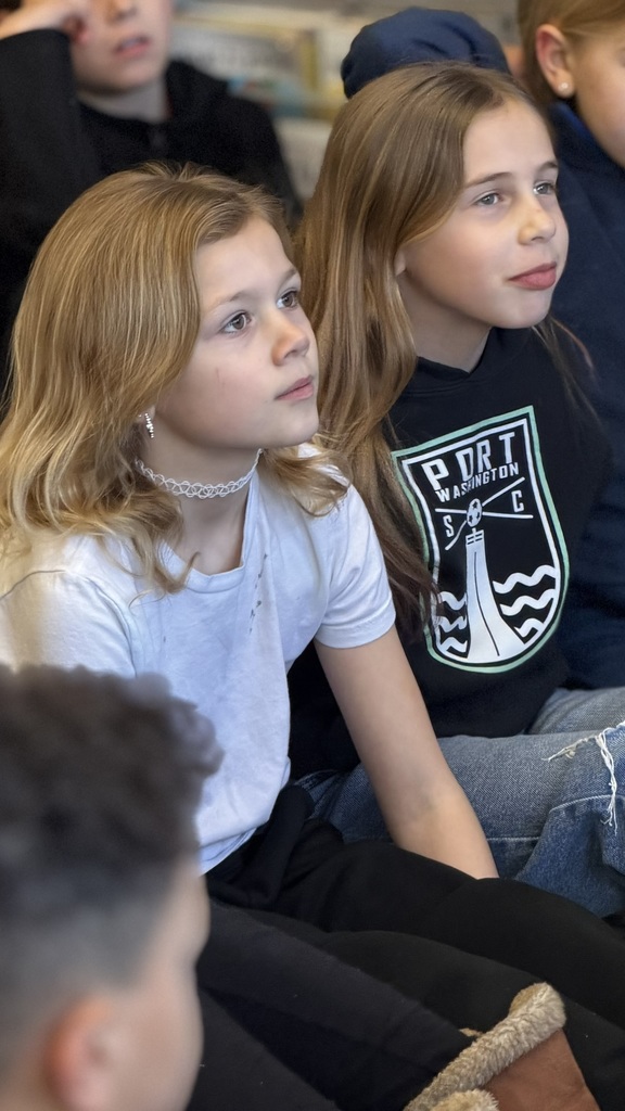 Two female students listening to a read aloud book