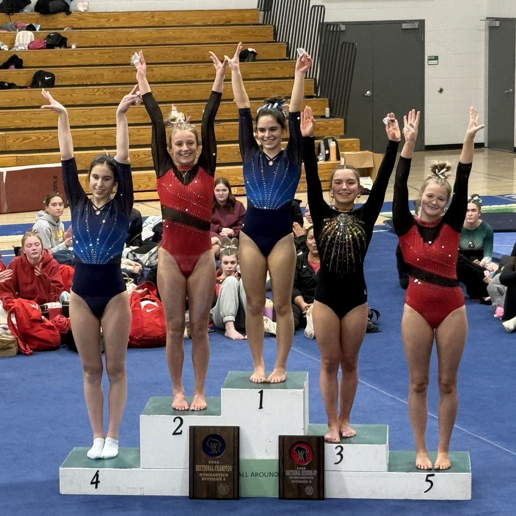 Podium of gymnasts getting medals