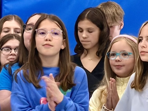 female student clapping and smiling