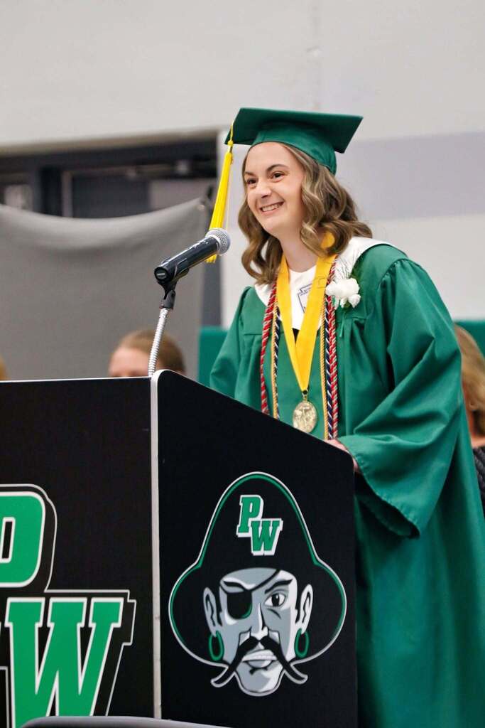 student speaking at graduation at a podium