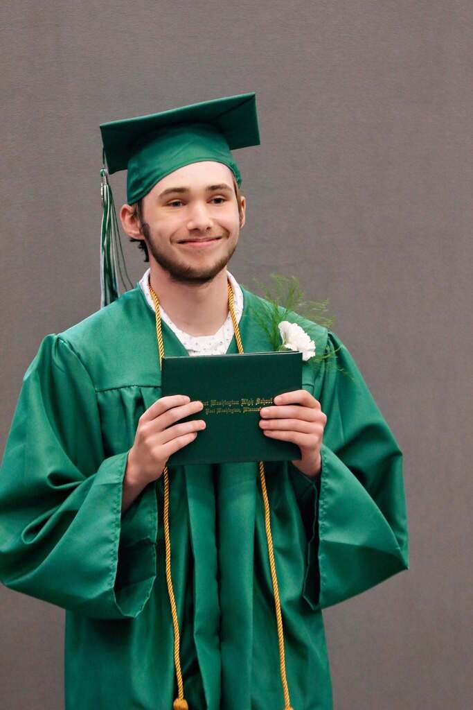 Student smiling in graduation attire