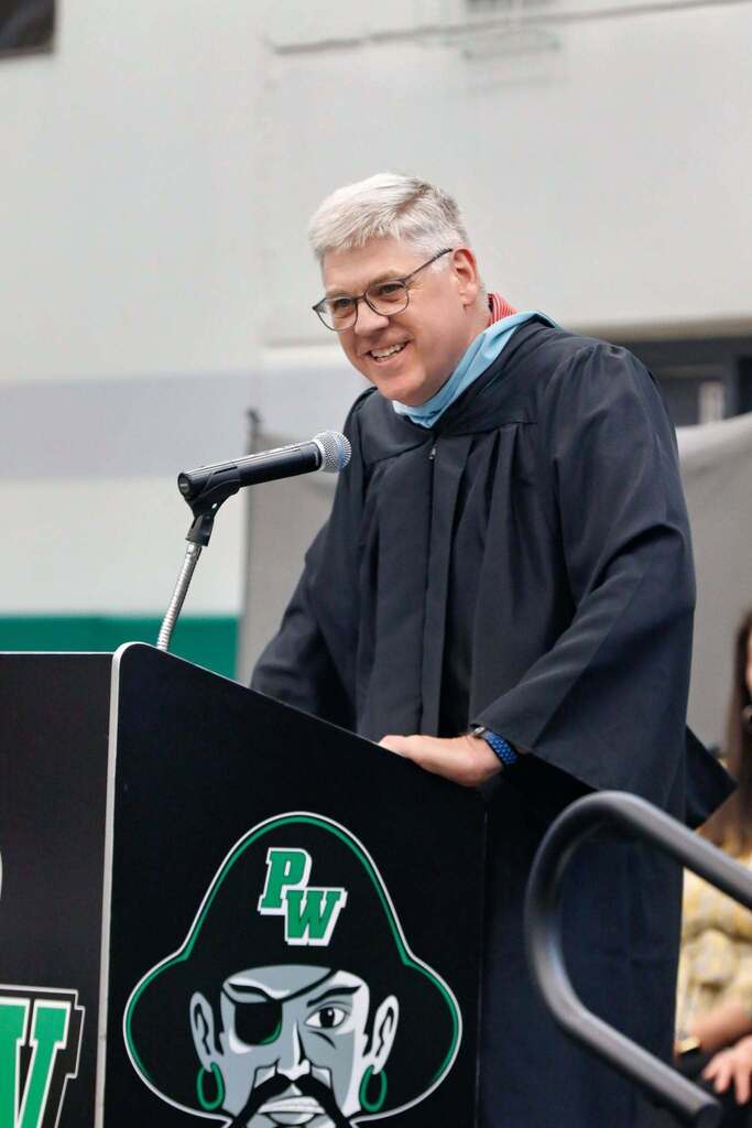 teaching speaking at graduation at a podium