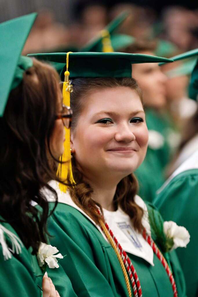 Student smiling in graduation attire