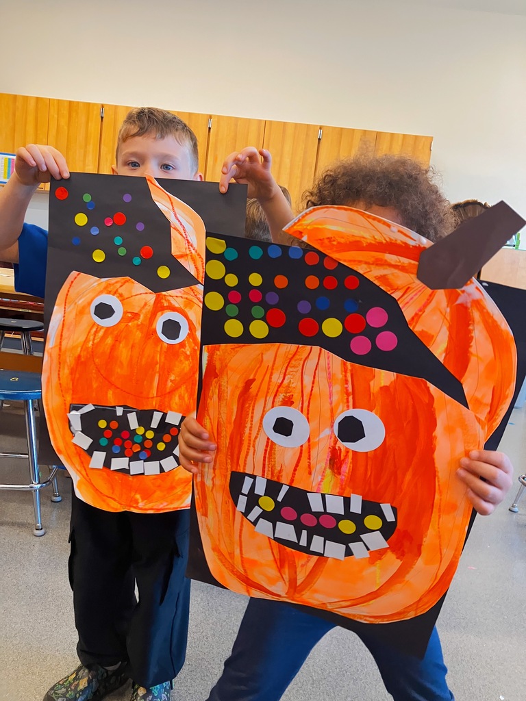 Students Holding Kindergarten Pumpkin Artwork