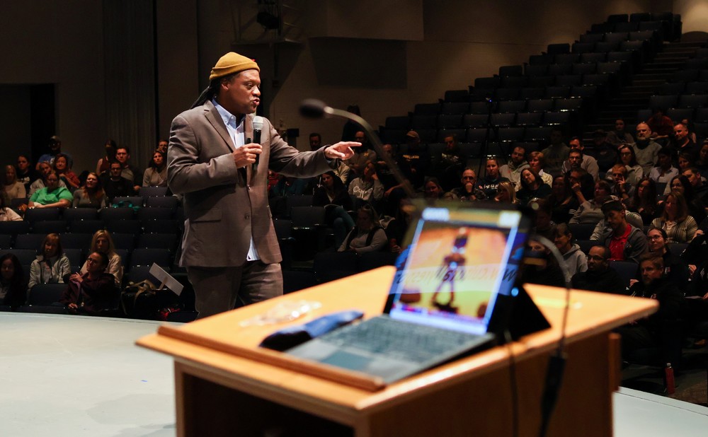 The presenter talking to an auditorium of people