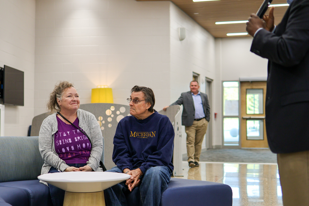 a woman smiles looking at a table of teachers
