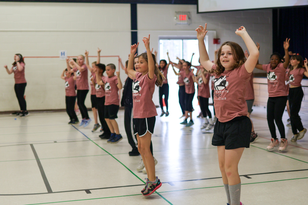 students perform a dance in a gym