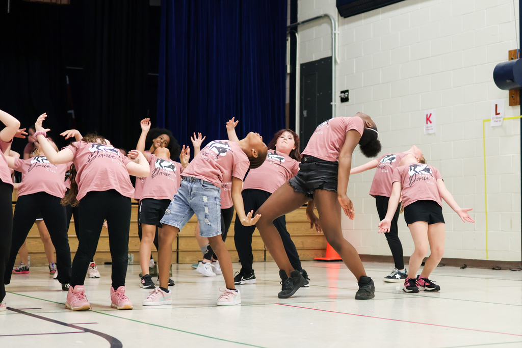 students perform a dance in a gym