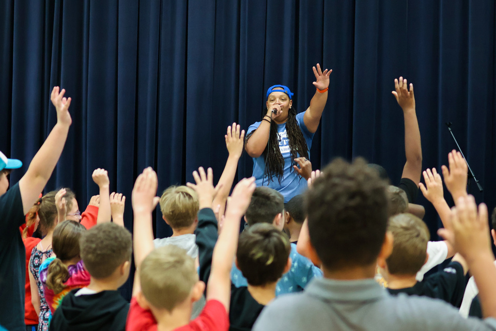 a rapper performs in front of a group of students