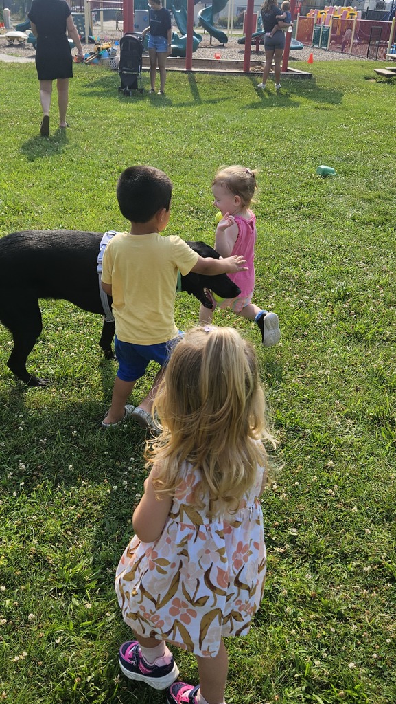 kids petting a black lab