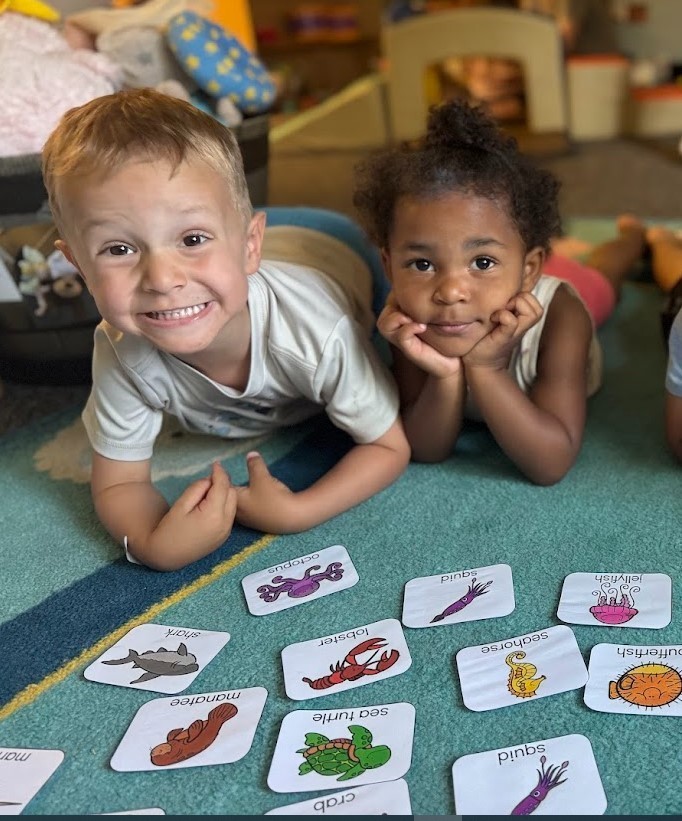 Two toddlers playing a matching game.