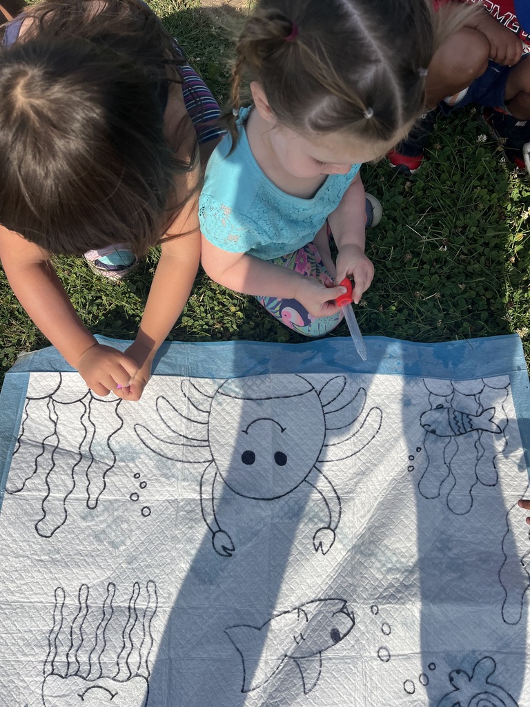 painting sea animals outside together.