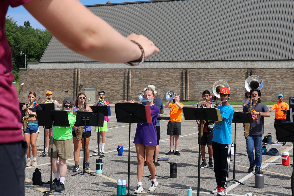 kids playing musical instruments in a school parking lot