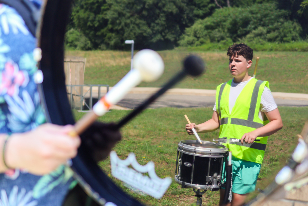 the reflection of a drummer in a bass drum