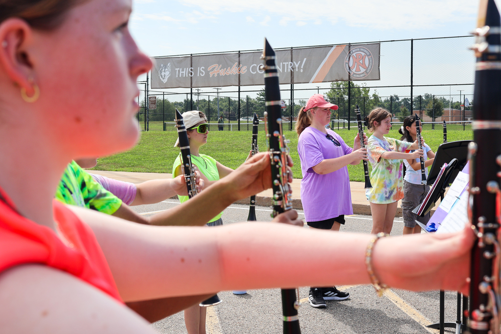 clarinet players standing at attention outside
