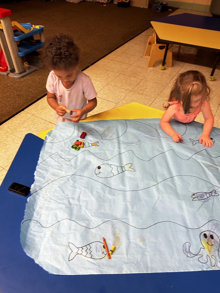 Two girls drawing oceans.