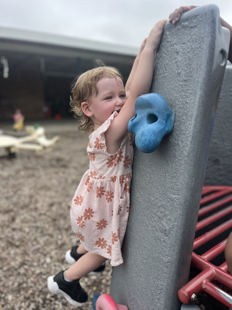 Girl playing on the swing set. 