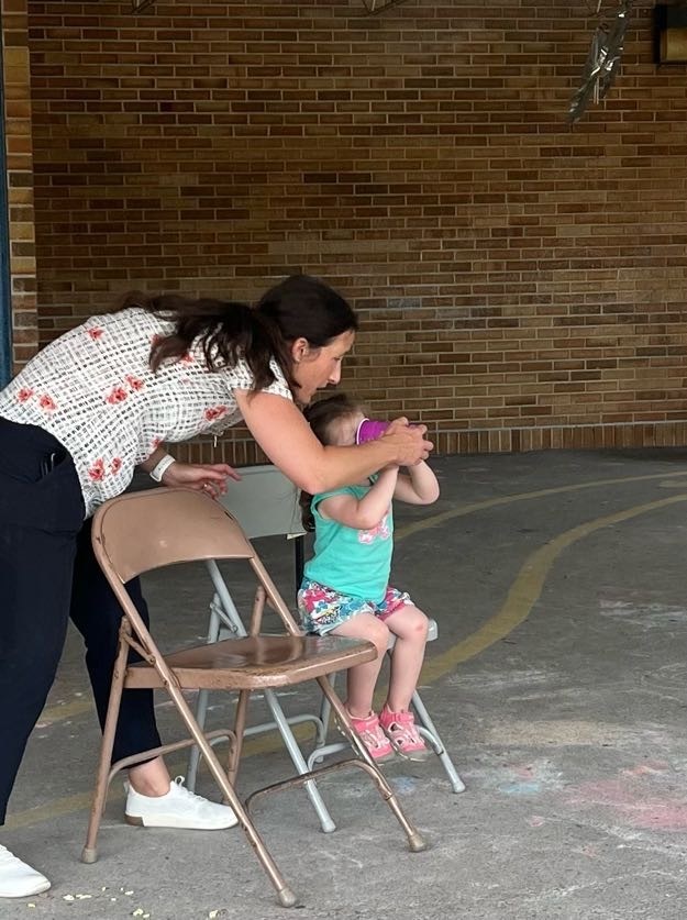 Mom helping with a snow cone. 