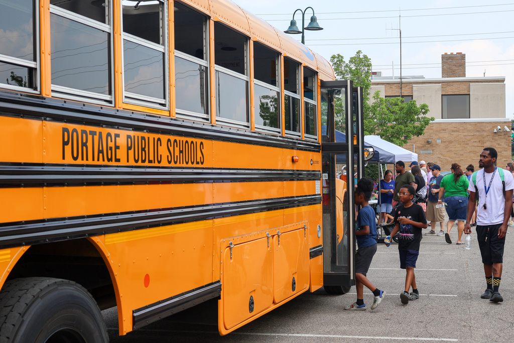 students walking on to a bus 
