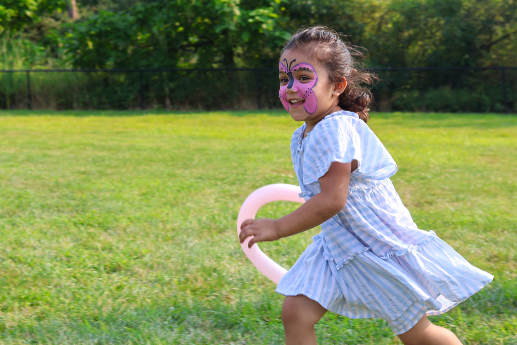 a little girl running through a field