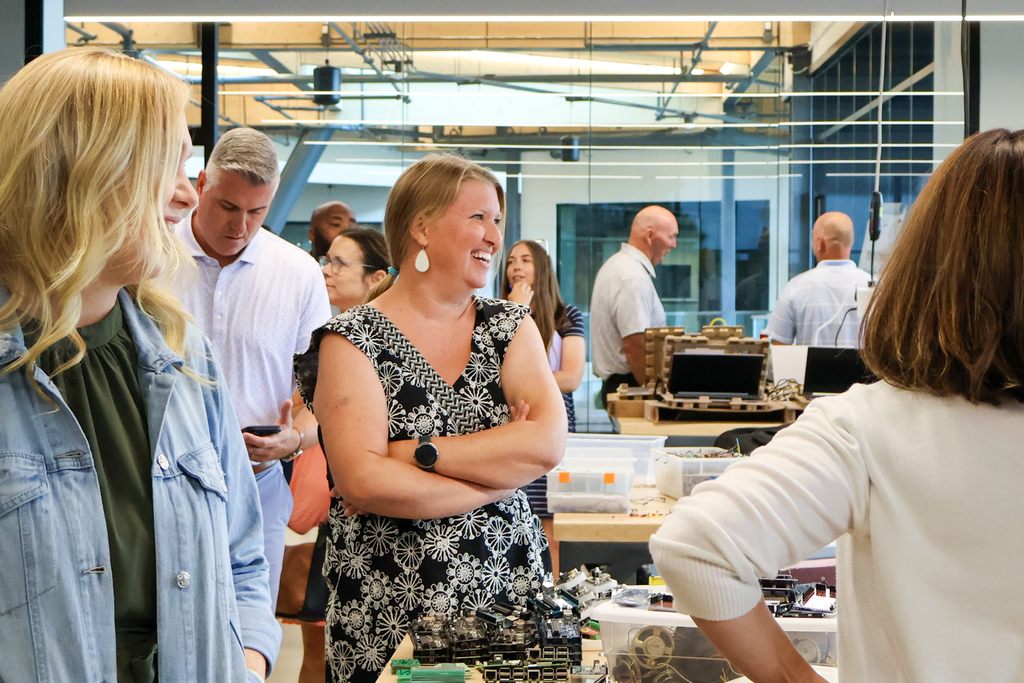 a woman smiles inside a classroom