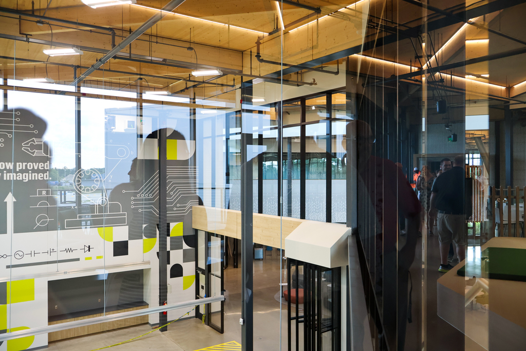 the reflection of people is seen on glass looking inside a career center