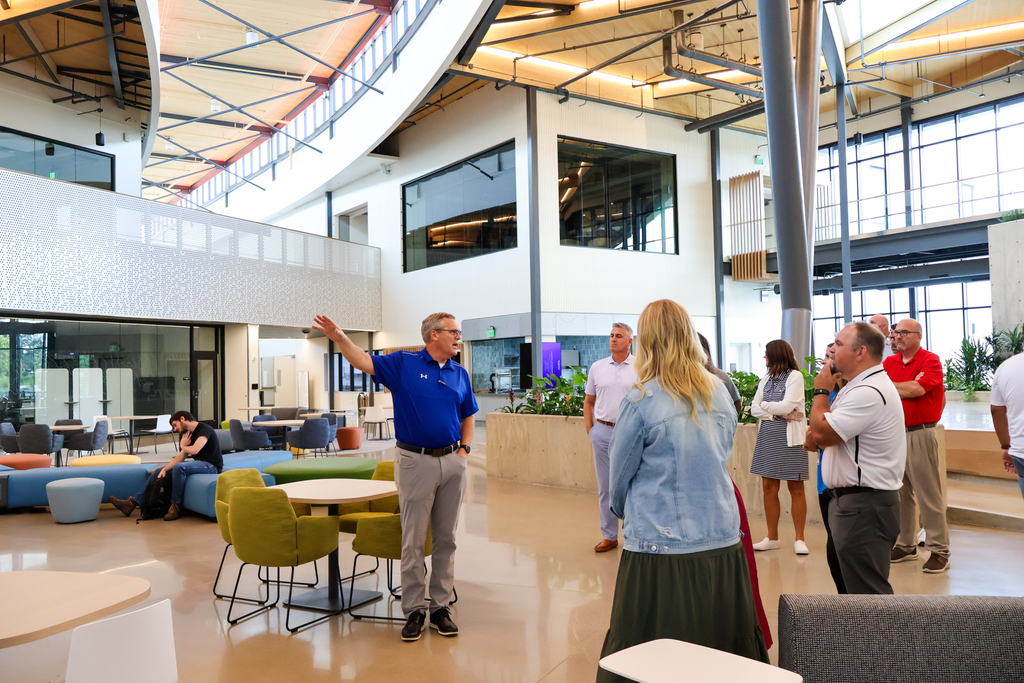 a man gives a group of people a tour through a CTE career center