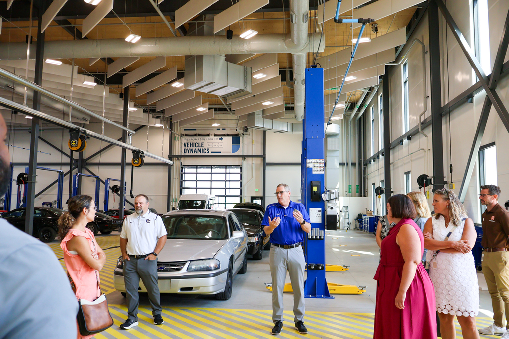 a man gives a group of people a tour through a CTE career center