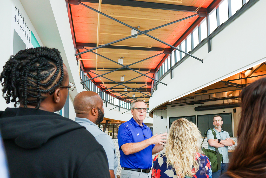 a man gives a group of people a tour through a CTE career center