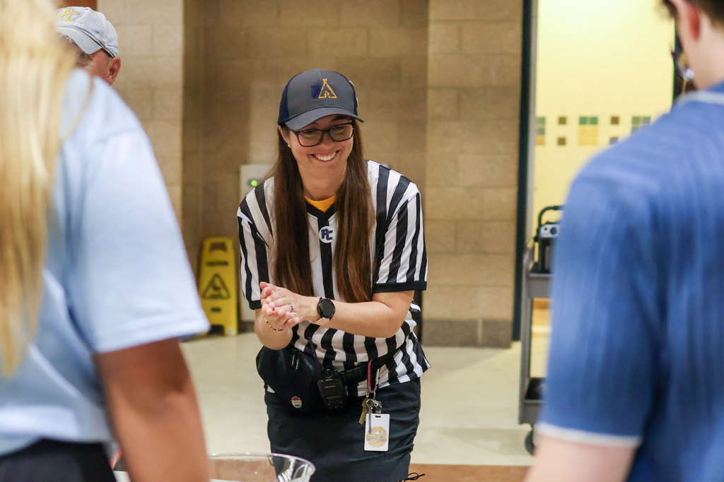 a woman wearing a ref outfit in a school cafeteria