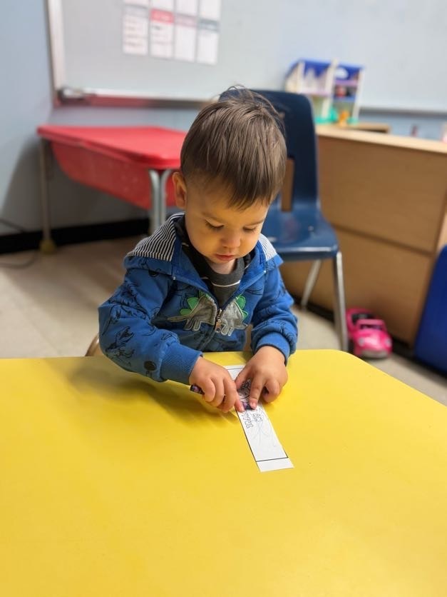 boy drawing at a table.