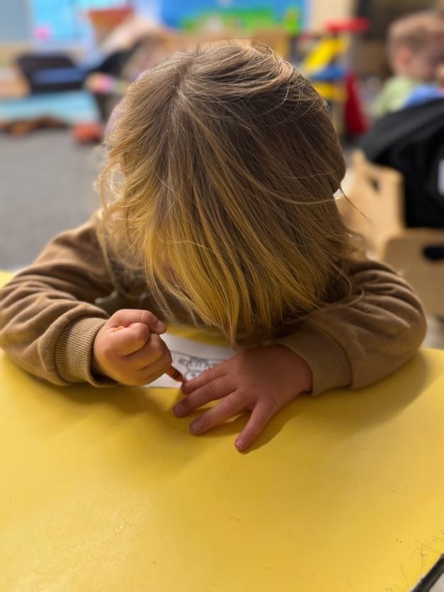 girl drawing on a table.