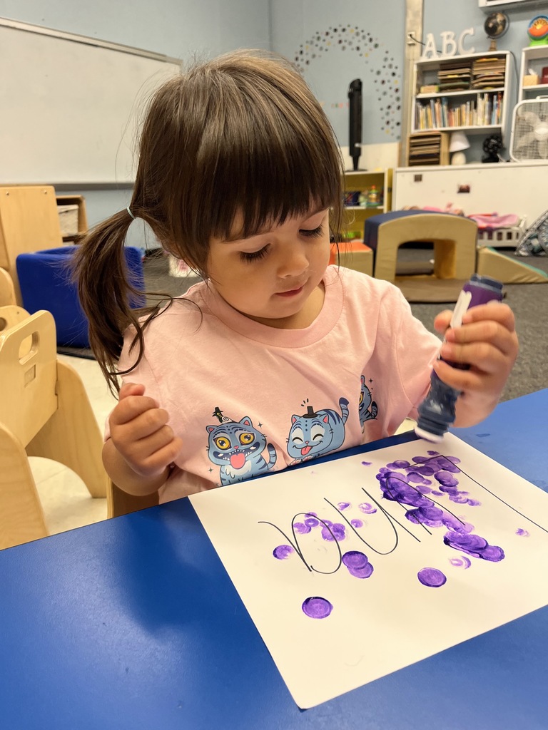 Little girl with purple paint.