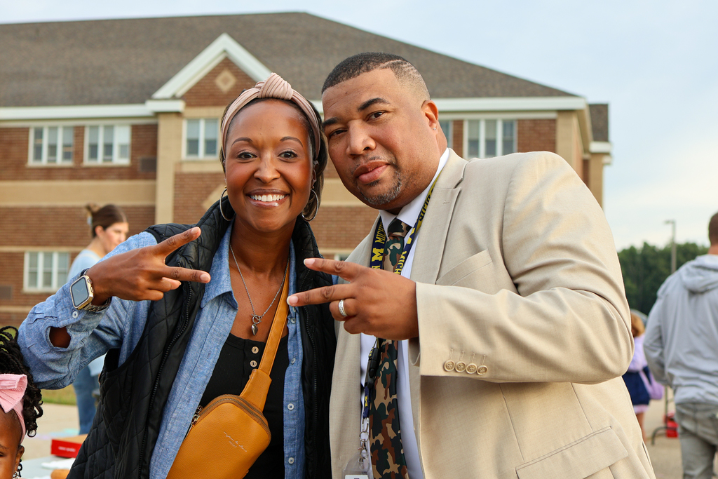 a man and woman pose together for a photo