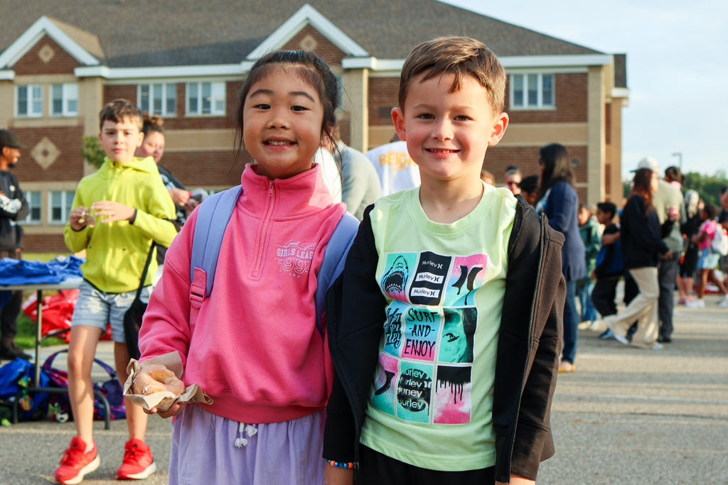 a boy and girl pose for a photo together