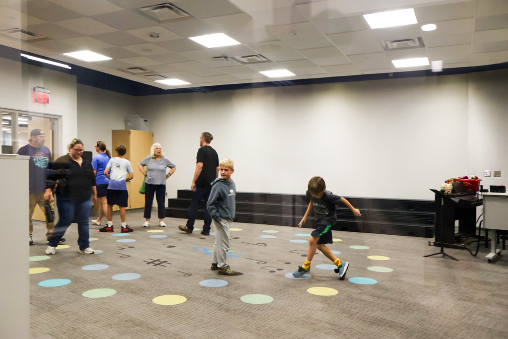 a boy dances around a music classroom