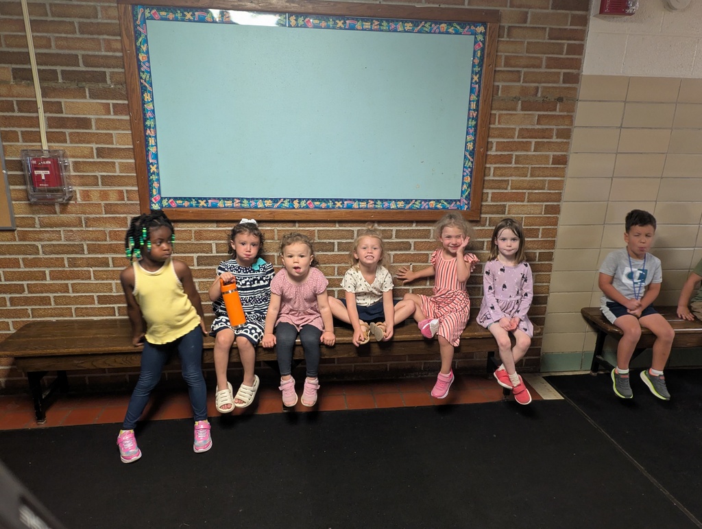 4 year olds sitting on a bench together.