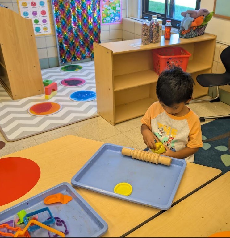 a little boy at a table.
