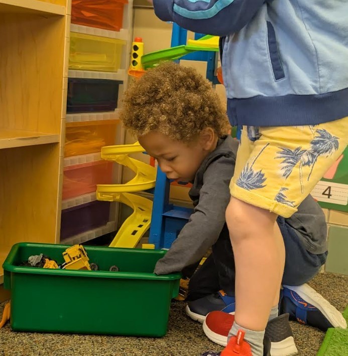 A student on the floor playing.