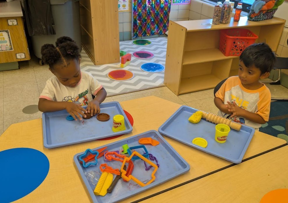 Two 3 Year Olds playing with playdough.
