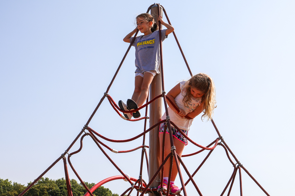 kids climbing on playground equipment