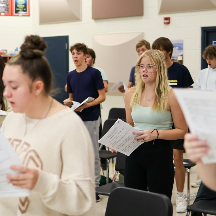 a girl singing in a choir room