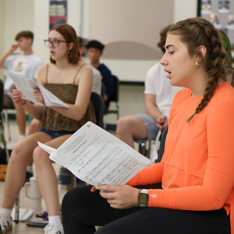 a girl singing in a choir room