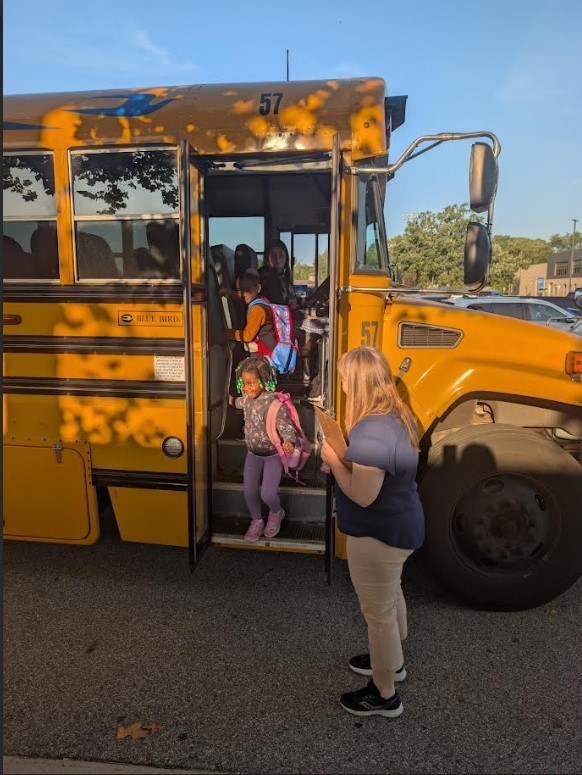 Little boy getting of the bus.