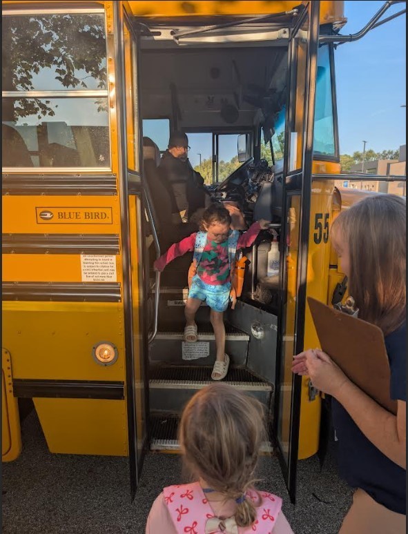 Girl getting off the bus.