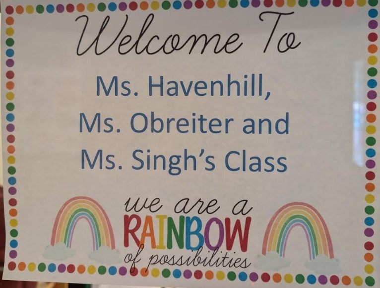 A door sign with rainbows.