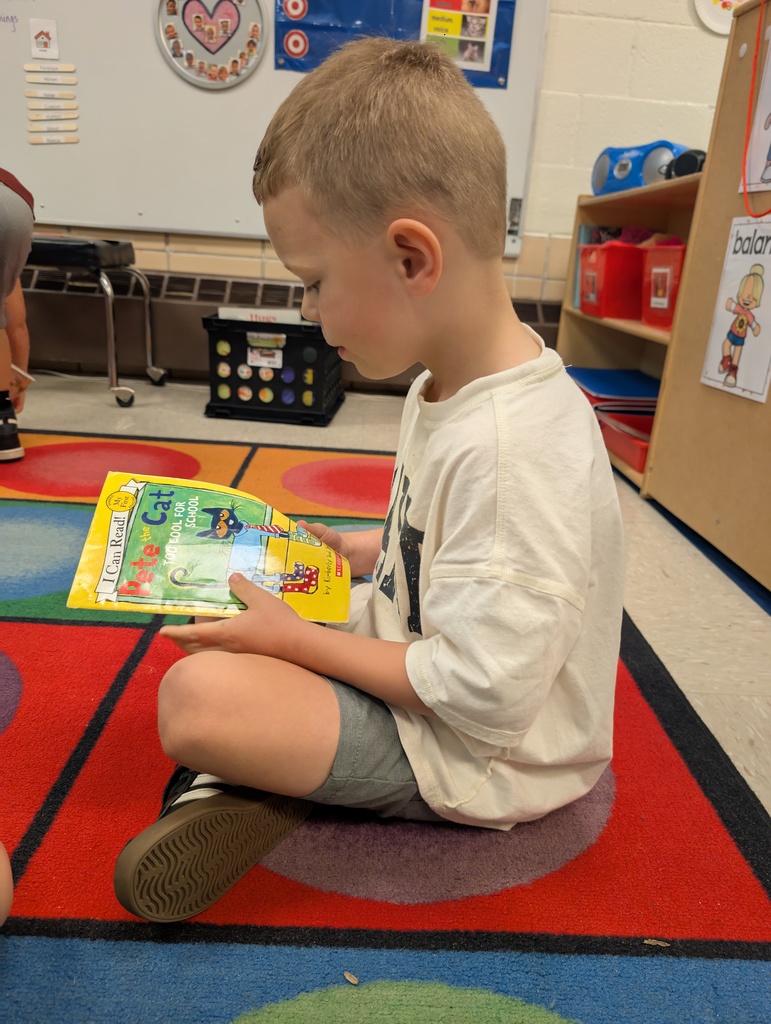 A boy student reading a book.