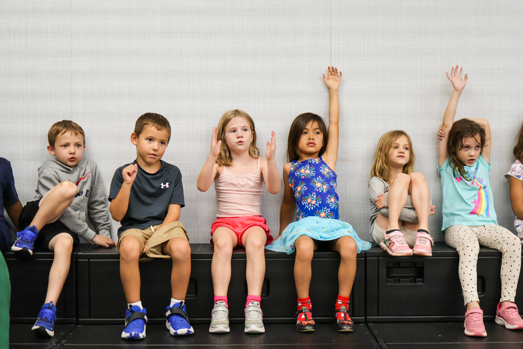 students sitting on risers in a classroom