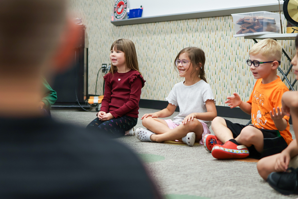 students sitting on a classroom floor