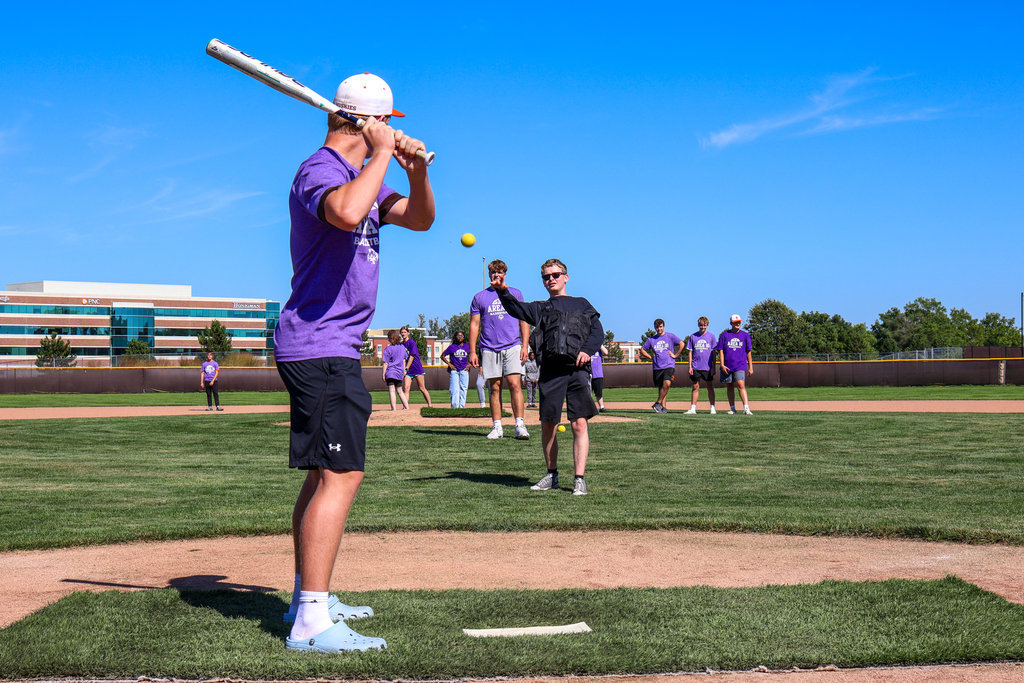 a boy up to bat on a softball field